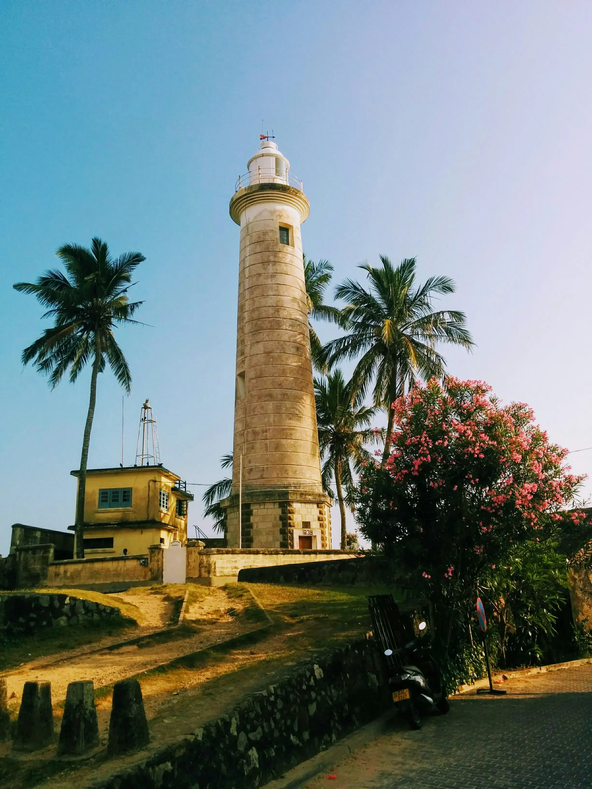 Galle Fort lighthouse surrounded by palm trees